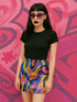 Psychedelic high waisted mini skirt for women featuring a trippy swirl print in yellow, pink, purple, and blue. Fitted bodycon silhouette with 1.5” elastic waistband, made from eco-friendly polyester and spandex blend. Available in sizes S to XL with built-in UPF 50 sun protection and odor-resistant, quick-dry performance fabric. Festival-ready, rave-approved, and styled for bold streetwear and summer outfits.